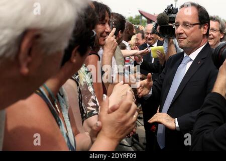 Il presidente francese Francois Hollande saluta la gente mentre lascia la fabbrica farmaceutica di AstraZeneca Dunkerque Production (AZDP) dopo una visita durante un viaggio incentrato sull'occupazione, a Dunkerque, nel nord-est della Francia, il 23 luglio 2013. Foto di Stephane Lemouton/ABACAPRESS.COM Foto Stock