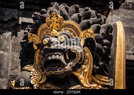 Il gigante nero Dvarapala (guardiano cancello) Con dettagli dorati al tempio Tanah Lot Foto Stock