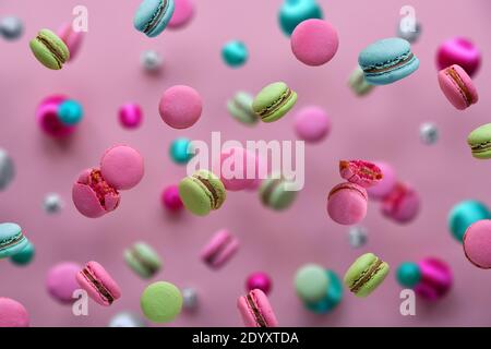 Levitazione di macaroni, concetto di cibo creativo. Colori rosa intenso, verde menta, blu menta e magenta. Macaroni volanti, palle da discoteca e. Foto Stock
