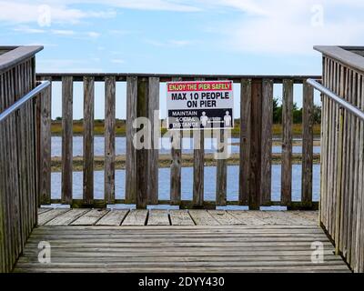 Segno di allontanamento sociale, promemoria, massimo dieci persone sul molo di pesca, Lower Suwannee National Wildlife Refuge, Levy County, Florida, USA. Foto Stock