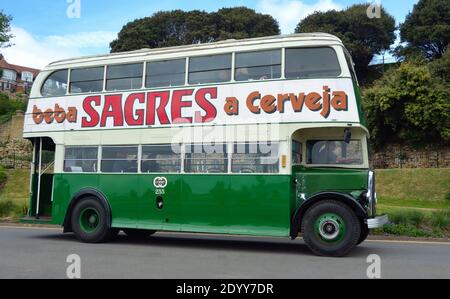 Autobus a due piani verde d'epoca con beba Sagres a Cerveja scritto sul lato. Foto Stock