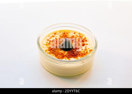 Crema brûlée con un pezzo di pralina al cioccolato sulla parte superiore Foto Stock