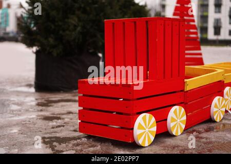 Auto in legno sul parco giochi. Inverno, alberi di Natale su uno sfondo sfocato Foto Stock