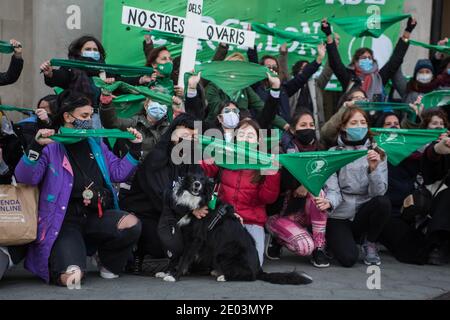 I manifestanti si riuniscono di fronte al consolato argentino mentre tengono fazzoletti verdi durante la dimostrazione. Il movimento argentino, Green Tide (Marea Verde) fa una chiamata di fronte al consolato argentino a Barcellona, Il giorno in cui il Senato argentino discute per dare una sanzione definitiva ad una legge che permette l'interruzione volontaria della gravidanza. Foto Stock