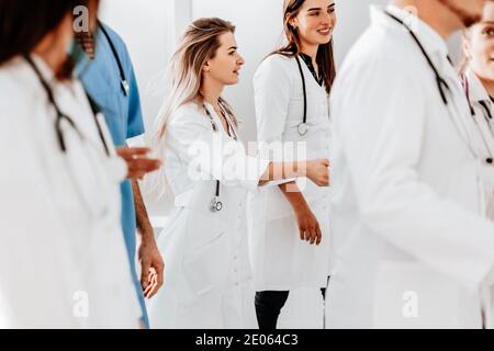 gruppo di medici che discutono qualcosa durante gli spostamenti Foto Stock