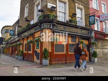 La gente passa davanti a un pub chiuso a Camden, Londra. Gran parte dell'Inghilterra si è spostata verso le restrizioni di livello 4 in quanto il Regno Unito vede un numero record di casi di coronavirus. Foto Stock