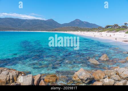 La gente sta godendo una giornata di sole alla baia di Wineglass in Tasmania, Australia Foto Stock