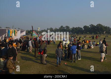 Lahore, Pakistan. 30 dicembre 2020. Pakistani un gran numero di famiglie siedono a terra partecipa al "Festival degli inverni di famiglia" al circuito automobilistico Jilani Park nella capitale provinciale Lahore. Le famiglie si divertono con il modello Dinosaur e lo spettacolo Breathing Fire from Mouth durante il "Family Winters Festival" all'ippodromo Jilani Park. (Foto di Rana Sajid Hussain/Pacific Press) Credit: Pacific Press Media Production Corp./Alamy Live News Foto Stock