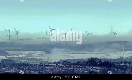 Glasgow, Scozia, Regno Unito. 31 dicembre 2020. Regno Unito Meteo: Il clima gelido di Whitelee Windfarm vide neve e nebbia mentre le turbine eoliche girarono nella più grande azienda eoliche onshore del Regno Unito, mentre il nuovo anno si chiama a sud della città, raffigurata da 10 miglia di distanza. Credit: Gerard Ferry/Alamy Live News Foto Stock