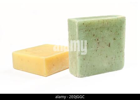 Due saponi di erbe naturali isolati su sfondo bianco. Prodotti di forma quadrata verde e gialla Foto Stock