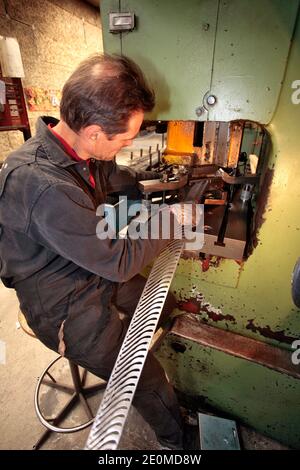 I lavoratori sono visti presso la fabbrica di coltelli 'la Forge de Laguiole' il 19 settembre 2012 a Laguiole, Francia centrale. I residenti di Laguiole, un villaggio sinonimo dei coltelli più famosi della Francia, hanno simbolicamente 'senza nome' la loro casa in una protesta per aver perso il controllo sul nome. Gli abitanti del villaggio sono furiosi che il nome Laguiole è passato nelle mani di un imprenditore che gli permette di essere utilizzato per vendere coltelli made-in-China e barbecue. Foto di Pascal Parrot/ABACAPRESS.COM Foto Stock