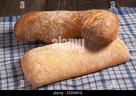 Pane ciabatta bianco e marrone su tovaglia blu Foto Stock