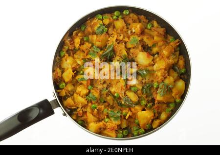 preparazione di patate piccanti cotte con altre verdure come cipolla e piselli verdi da farcite in masala dosa. Foto Stock