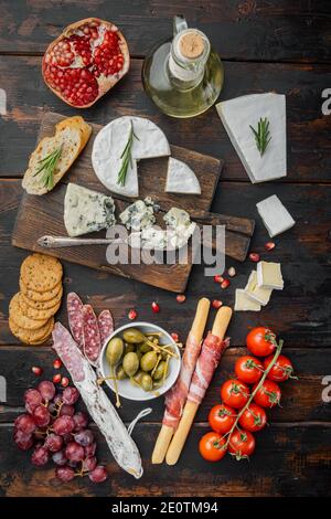 Spuntini spagnoli, formaggio di carne, set di erbe, su sfondo di legno scuro, piatto Foto Stock