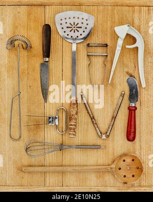 Attrezzi da cucina vecchi sul tagliere 1 Foto Stock
