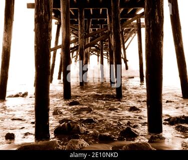 Il vecchio molo a Paradise Cove, Malibu, CA in seppia. Onde infrangenti e sole luminoso avevano bisogno di qualcosa di più del colore normale. Foto Stock