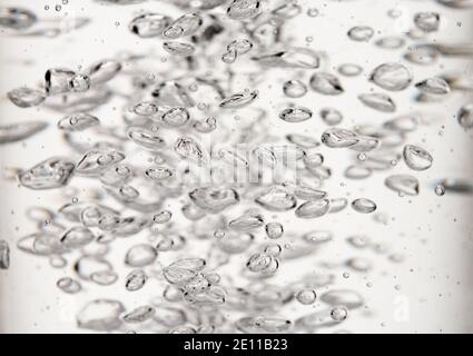 Bolle d'aria naturale nell'acqua su sfondo bianco. Foto Stock