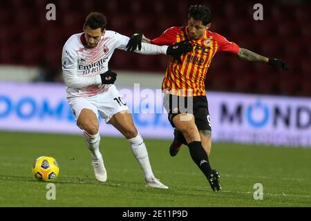 Il centrocampista turco di Milano Hakan Calhanoglu sfida la palla con L'attaccante italiano Gianluca Lapadula di Benevento durante la serie A. Partita Benevento vs AC Milan Foto Stock