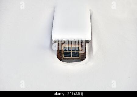 Finestra di una casa di legno con icicles Foto Stock