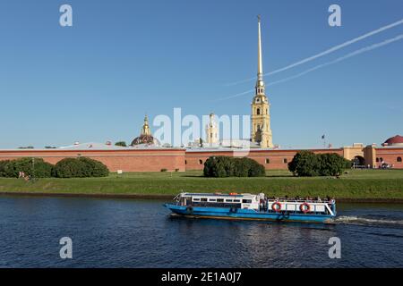 La gente del tour in barca passa attraverso il canale Kronverk contro la fortezza di San Pietro e Paolo con la cattedrale di San Pietro e Paolo a San Pietroburgo, Russia Foto Stock