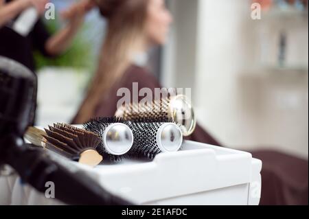 Strumenti professionali per parrucchieri . Primo piano di spazzole rotonde sullo sfondo di un parrucchiere durante il lavoro Foto Stock