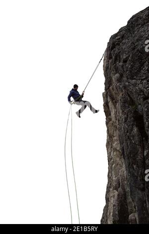 Epico avventuroso Extreme Sport composito di Rock Climbing Man Rappelling da una scogliera. Foto Stock