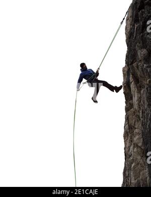 Epico avventuroso Extreme Sport composito di Rock Climbing Man Rappelling da una scogliera. Foto Stock