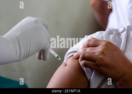 Kolkata, India. 8 gennaio 2021. Un volontario di vaccinazione sta vaccinando un operatore in prima linea durante il ciclo a secco del vaccino COVID-19. La corsa secca del vaccino COVID-19 sta avvenendo in tutto il Bengala occidentale con tre siti a Kolkata, 69 nel Bengala occidentale. Secondo i funzionari del dipartimento sanitario, la vaccinazione di massa inizierà molto presto in India. Credit: SOPA Images Limited/Alamy Live News Foto Stock