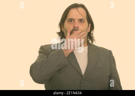 Uomo d'affari caucasico grasso cercando scioccato mentre coprendo la bocca Foto Stock