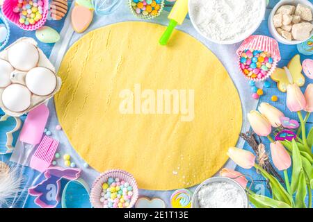 Famiglia fatta in casa vacanza pasta di Pasqua concetto. Pasqua cottura sfondo con la mamma e la figlia bambino mani, piano vista dall'alto. Con l'impasto, si forma la cupcake Foto Stock