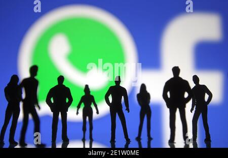 In questa illustrazione fotografica le sagome delle figure giocattolo persone viste di fronte al WhatsApp e Facebook logos.in gennaio 2021, WhatsApp ha annunciato una nuova politica sulla privacy che consentirà a WhatsApp di condividere i dati con Facebook, e gli utenti accetteranno la nuova politica entro l'8 febbraio 2021, oppure interrompa l'utilizzo dell'app, secondo quanto riferito dai media. Foto Stock