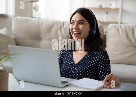 Donna di razza mista felice millennial godendo di studio online. Foto Stock