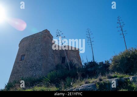 Torre medievale di Tamaray a Almuñécar (Spagna) su una collina Con vegetazione caratteristica della costa mediterranea su un soleggiato mattina invernale Foto Stock
