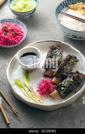 Costolette di manzo in stile coreano con ravanelli colorati e riso, vista ravvicinata. Foto Stock