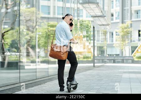 Scooter elettrico uomo alla moda Foto Stock