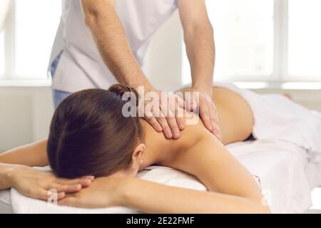 Paziente di donna che ottiene massaggio di ritorno da massaggiatore professionale Foto Stock