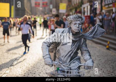 Edimburgo, Scozia - Agosto 16 2016: Un artista di strada si pone come una statua vivente di fronte al Tolbooth Kirk sul Royal Mile durante il P. Foto Stock