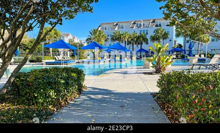 Orlando, FL USA - 4 Gennaio 2021: Un complesso di servizi nelle vicinanze che appare come un resort con palme, getti d'acqua e cabanas. Foto Stock