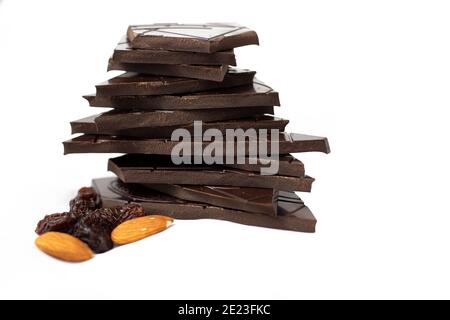 Pezzi da closeup di cioccolato fondente, mandorle e uvetta su sfondo bianco Foto Stock