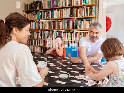 Carte da gioco per la famiglia al tavolo Foto Stock