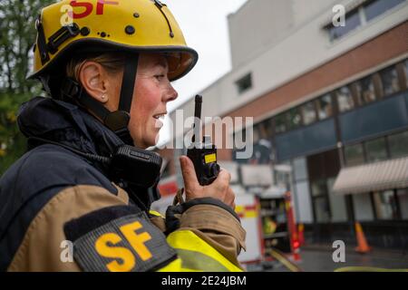 Pompiere che parla tramite walkie talkie Foto Stock