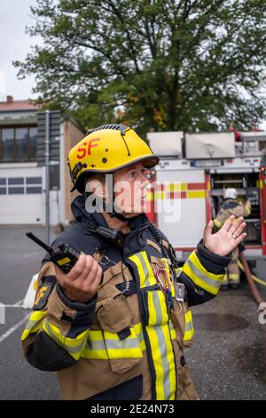 Pompiere che parla tramite walkie talkie Foto Stock