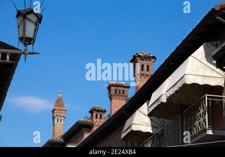 Fila di diversi camini in pietra sul tetto di una casa italiana, Italia Foto Stock