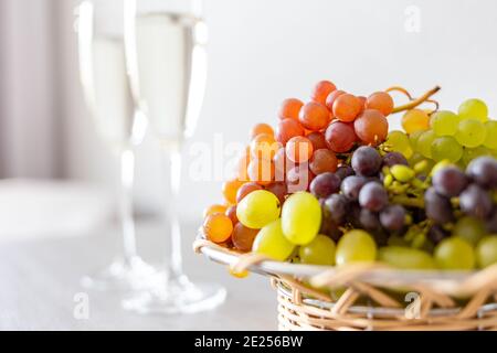 Cesto con uva e bicchieri di spumante Foto Stock