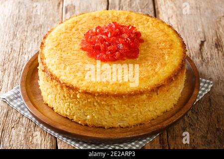 Il tahchin di pollo speziato è un casseruola di torta di riso orlato croccante persiano che consiste principalmente di riso, yogurt, uova e chiocciole di zafferano nel piatto Foto Stock