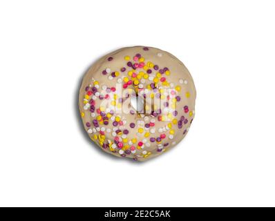 Bella ciambella rotonda smaltata con cioccolato bianco e colorato giallo chiaro, viola, rosa e bianco decorazione. Vista direttamente dall'alto. Ciambella con Foto Stock