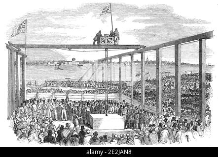 Cerimonia di posa della prima pietra dei moli di Birkenhead, 1844. La pietra di fondazione è posata a Birkenhead sul fiume Mersey: '...lo spettacolo nel momento in cui la pietra è stata abbassata al suo posto, e Sir P Egerton [paleontologo e politico Philip de Malpas Grey Egerton] sta ricevendo il cazzone'. Da "Illustrated London News", 1844, Vol V. Foto Stock