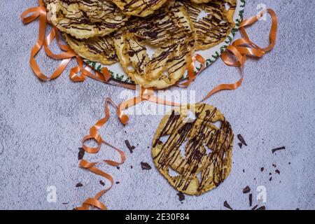 chatter o bugie, una torta di carnevale ricoperta di cioccolato fondente Foto Stock