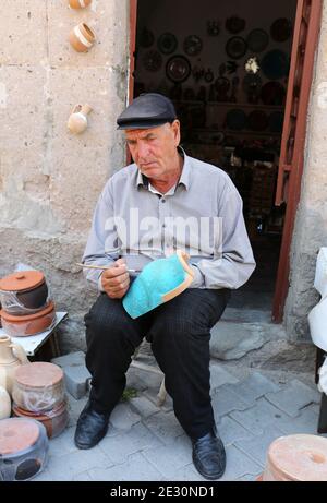 AKSARAY, TURCHIA-LUGLIO 22:Unidentified Pottery artista colorazione vaso di fronte store.Luglio 22,2017 ad Aksaray, Turchia. Foto Stock