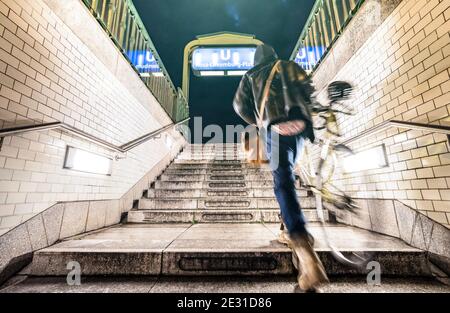 Uomo sfocato sfocato con la moto che esce da Rosa Luxemburg Stazione della metropolitana di Berlino - concetto di vita urbana con ragazzo di strada alla metropolitana Foto Stock